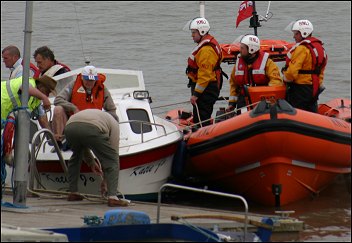 The powerboat crew are delivered back to the shore