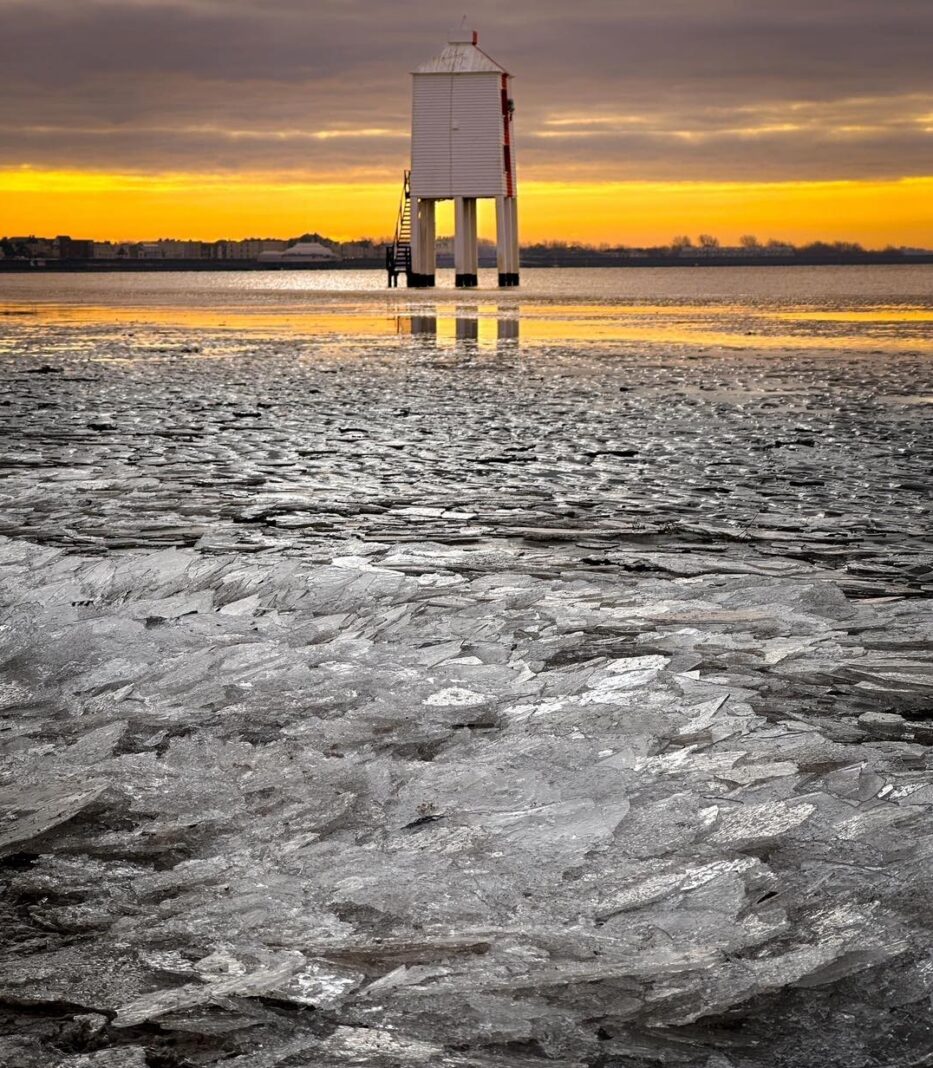 Ice forms along Burnham On Sea beach tideline during freezing weather