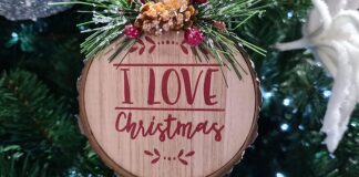 a wooden ornament hanging from a christmas tree