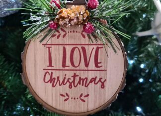 a wooden ornament hanging from a christmas tree