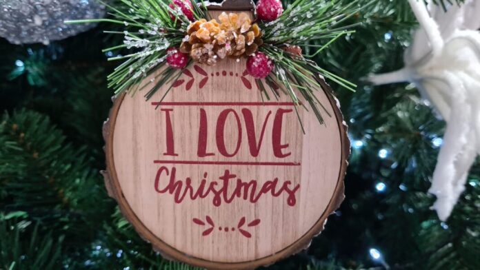 a wooden ornament hanging from a christmas tree